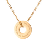 Gold necklace with a round pendant on a white background